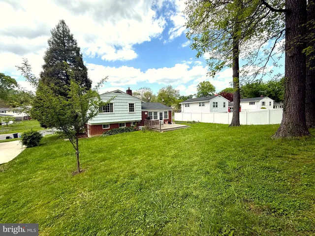 a view of a yard with a house and large trees
