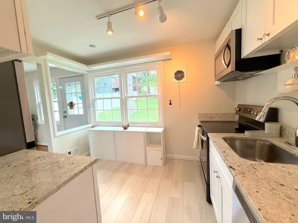 a kitchen with a sink a stove and a refrigerator
