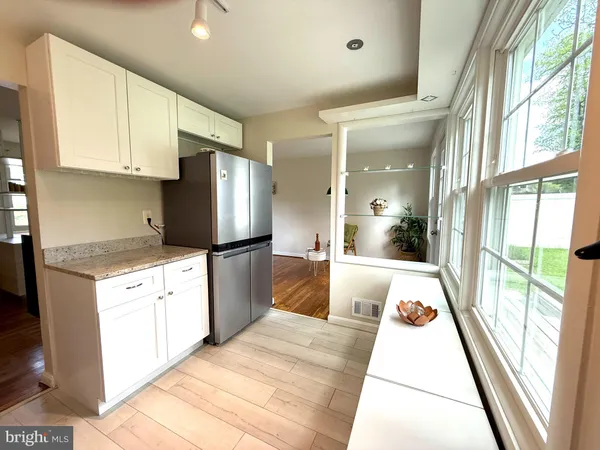 a large white kitchen with a large window