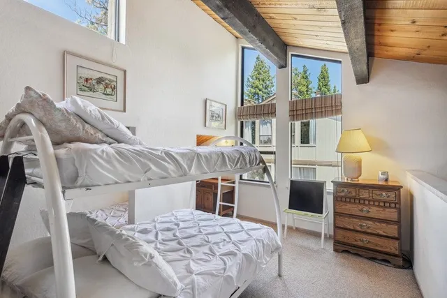 a bedroom with a bed and a table