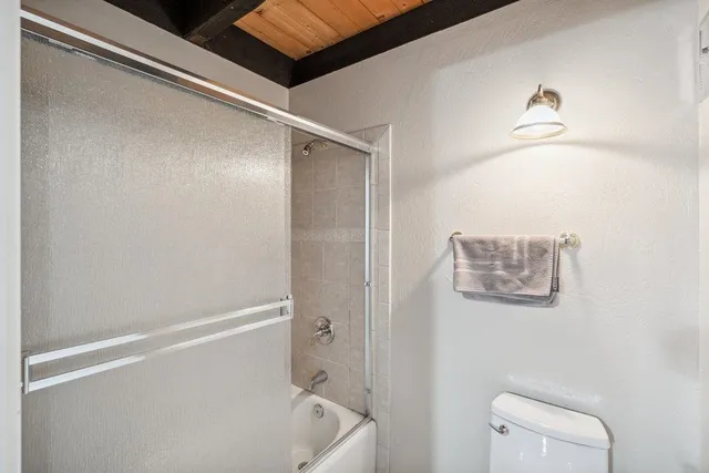 a bathroom with a shower and a toilet