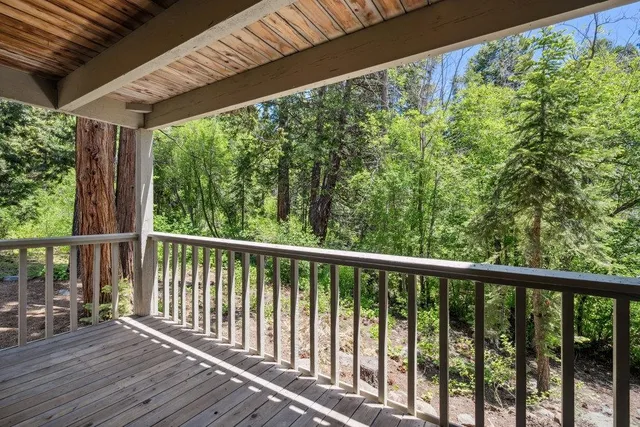 a view of a balcony with wooden floor