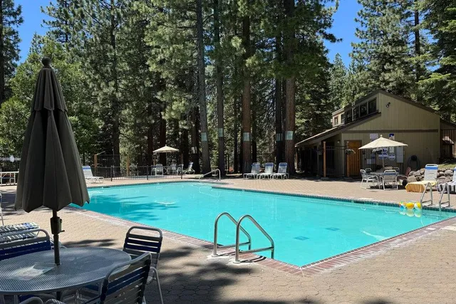 a view of a swimming pool and lounge chairs