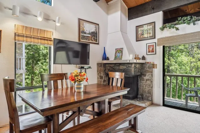 a living room with furniture a flat screen tv and a floor to ceiling window