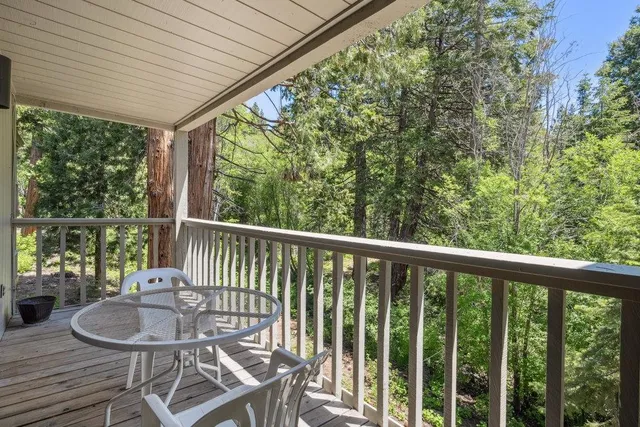 a view of a balcony with furniture and wooden deck