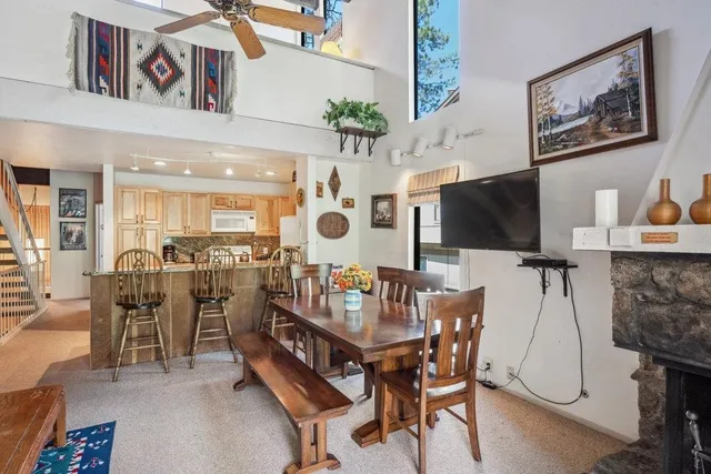 a view of a dining room with furniture and a flat screen tv