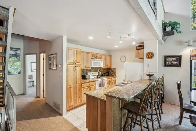 a view of a dining room with furniture and a kitchen