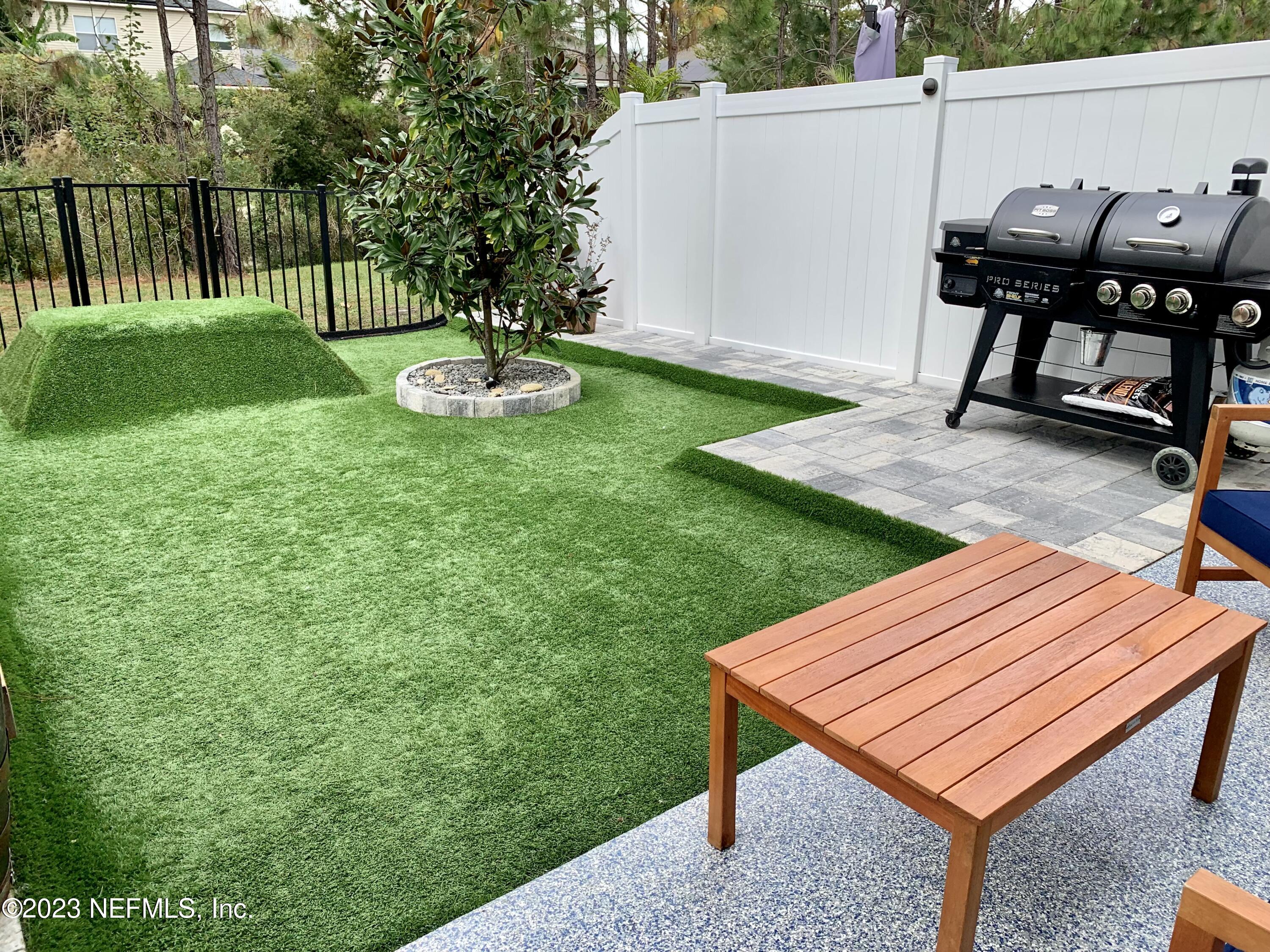 25 Ridge Lake Road St. Augustine, FL 32086 - Photo 16 of 27 a view of a backyard with a chair and a table