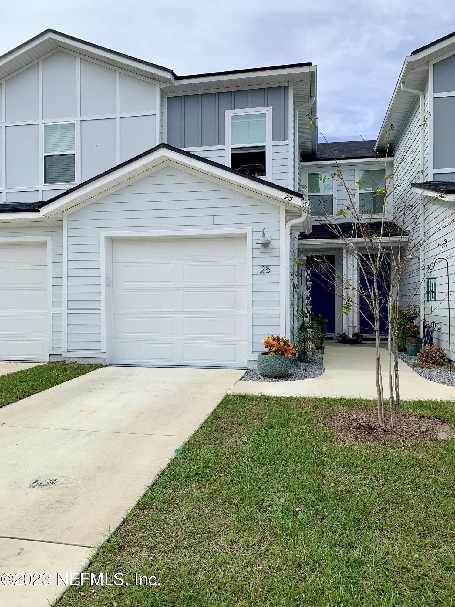 25 Ridge Lake Road St. Augustine, FL 32086 - Photo 20 of 27 a view of a house with a backyard and a garage
