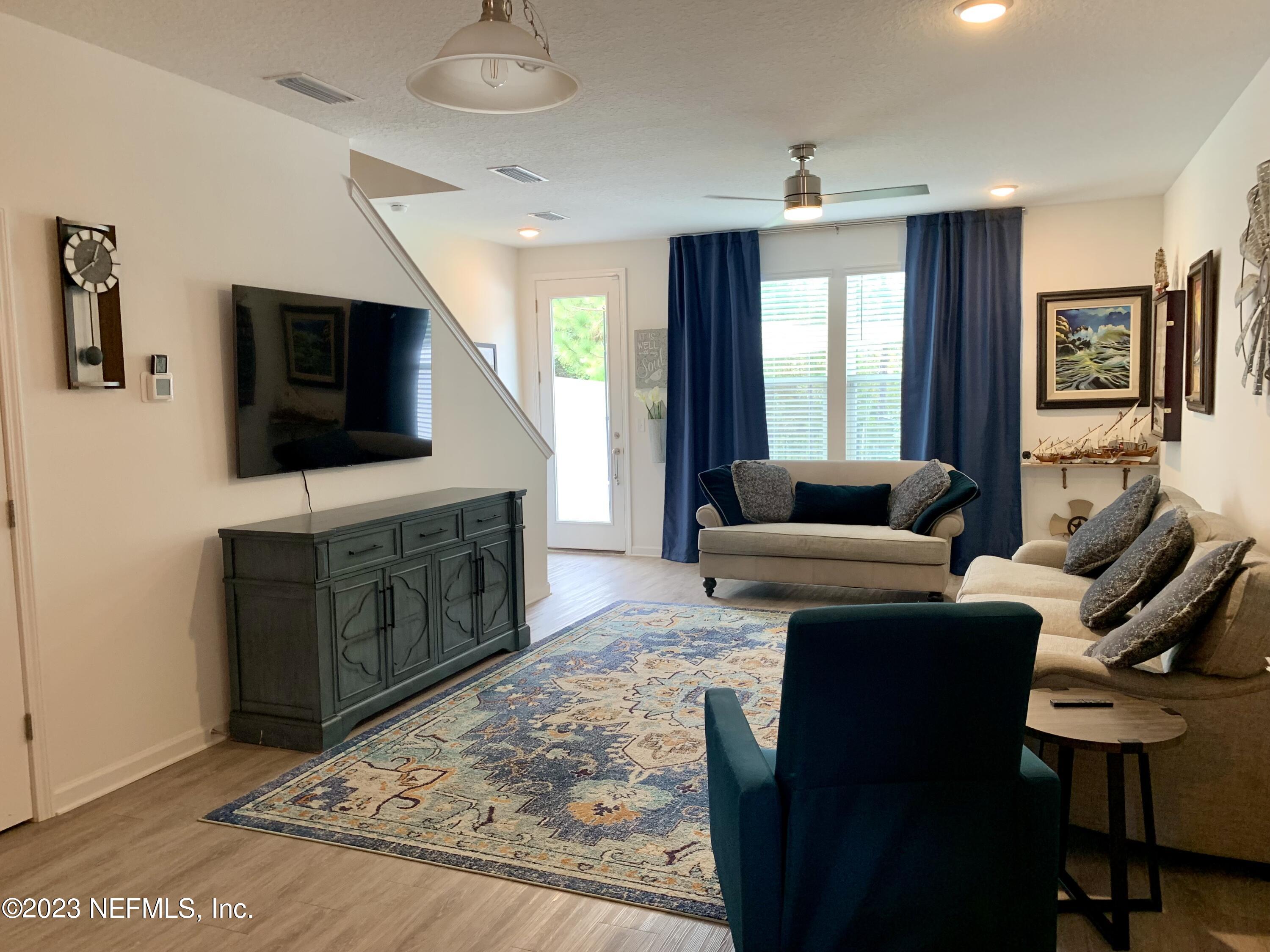 25 Ridge Lake Road St. Augustine, FL 32086 - Photo 2 of 27 a living room with furniture and a flat screen tv