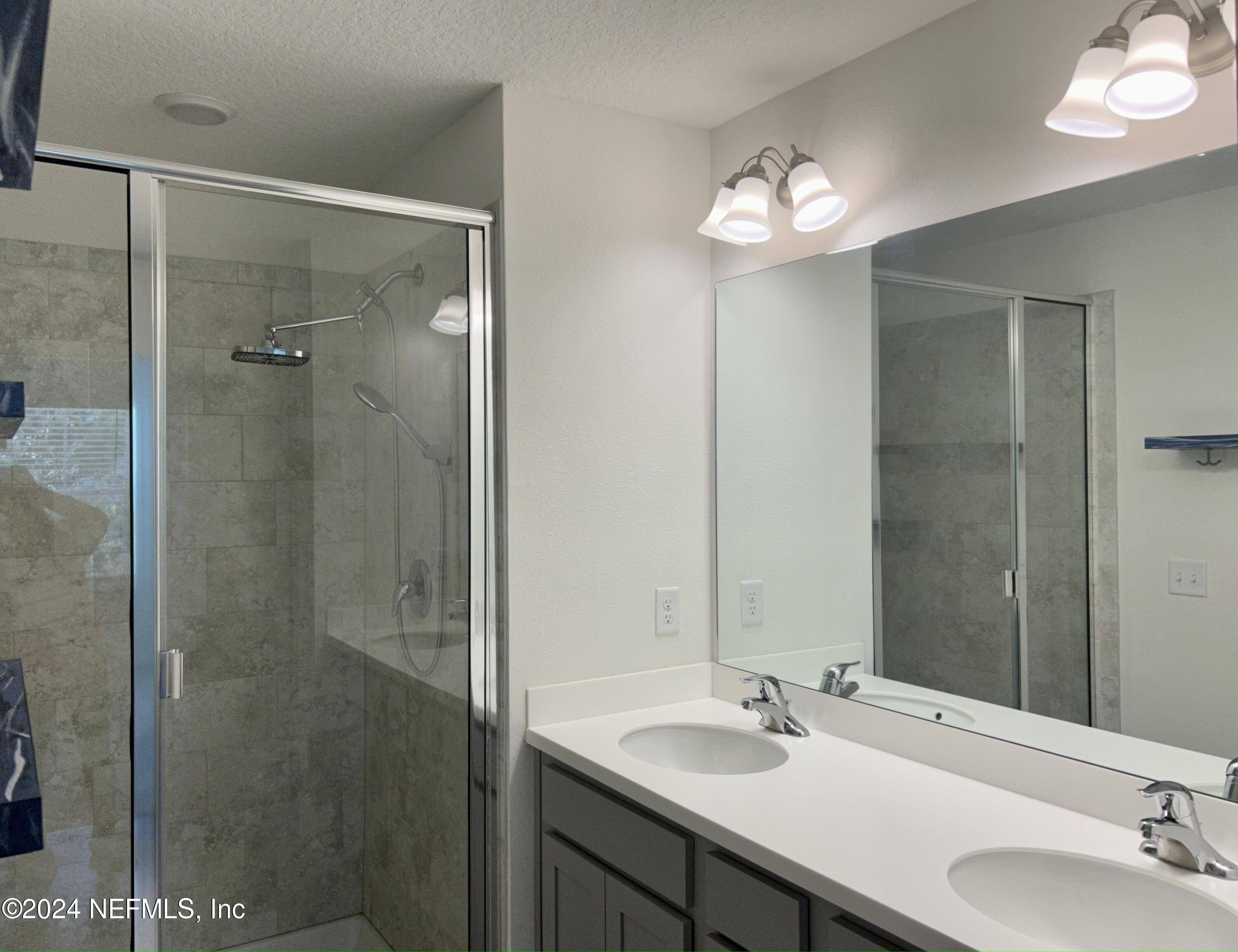 25 Ridge Lake Road St. Augustine, FL 32086 - Photo 5 of 27 a bathroom with a double vanity sink and a mirror