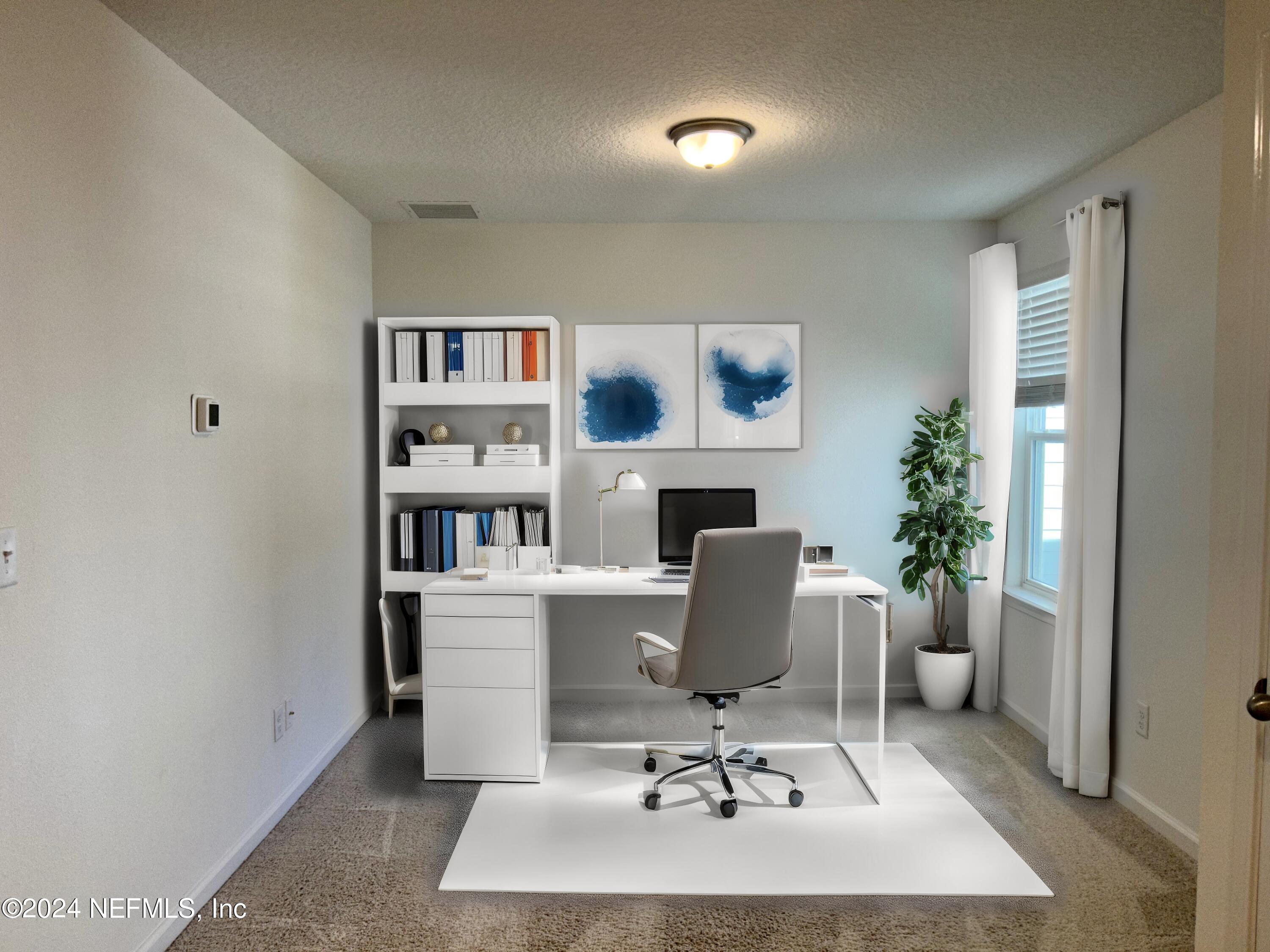 25 Ridge Lake Road St. Augustine, FL 32086 - Photo 6 of 27 a workspace with a bookshelf