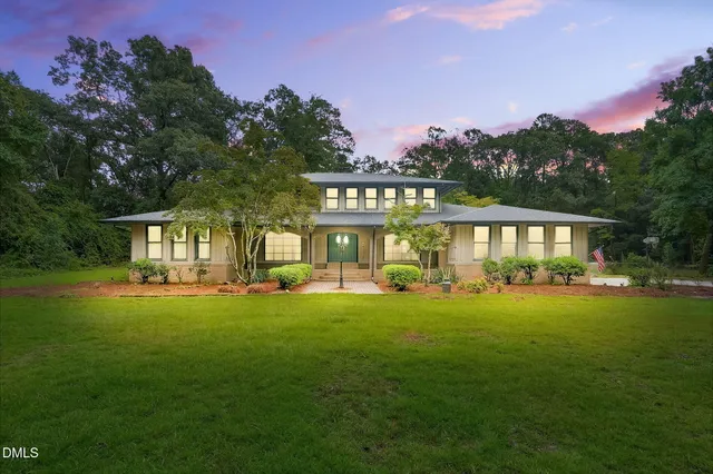 a front view of a house with swimming pool having outdoor seating