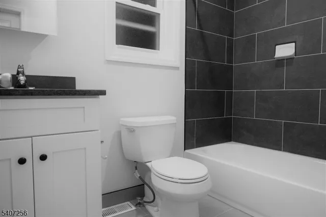 a bathroom with a toilet and a bathtub