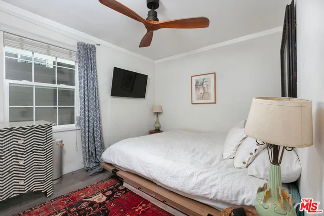 a bedroom with a bed and a television