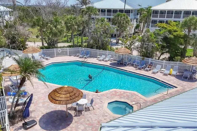a swimming pool with outdoor seating and yard