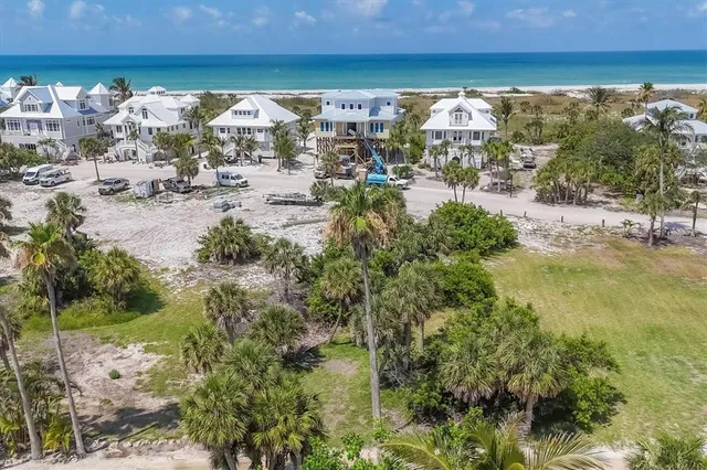 a view of a lake with lawn chairs