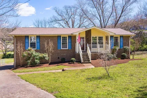 a front view of house with yard porch and furniture