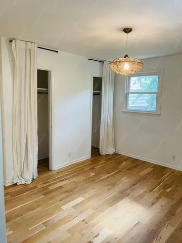 a view of an empty room with a chandelier