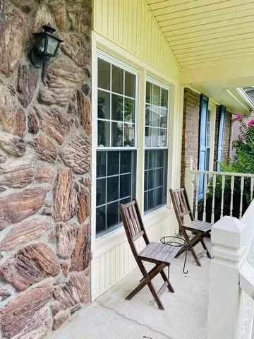 a view of a lounge chair in the house front of house