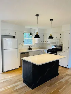 a kitchen with kitchen island a stove a refrigerator and a sink