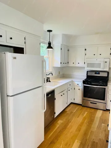 a kitchen with stainless steel appliances a refrigerator sink and cabinets