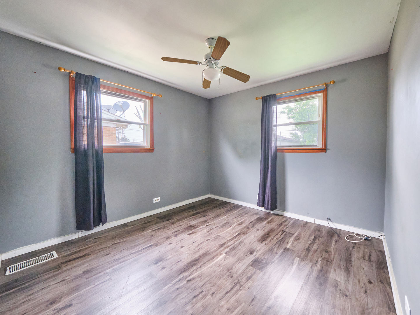 109 George Road Wheeling, IL 60090 - Photo 5 of 12 a view of empty room with wooden floor and fan