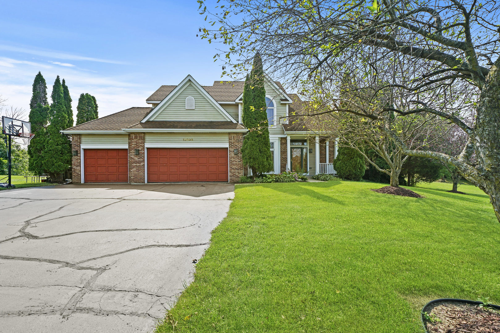 10808 Michigan Drive Spring Grove, IL 60081 - Photo 1 of 26 a front view of a house with a garden