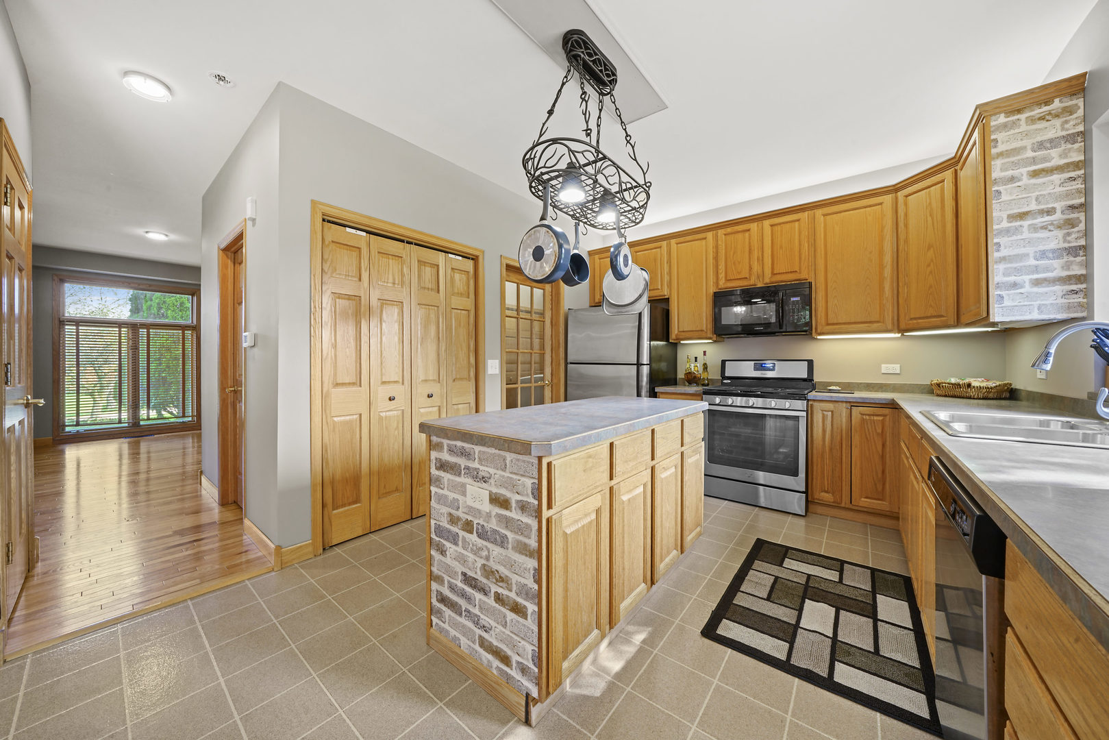 10808 Michigan Drive Spring Grove, IL 60081 - Photo 12 of 26 a kitchen with stainless steel appliances granite countertop a stove a sink dishwasher and a refrigerator with wooden floor