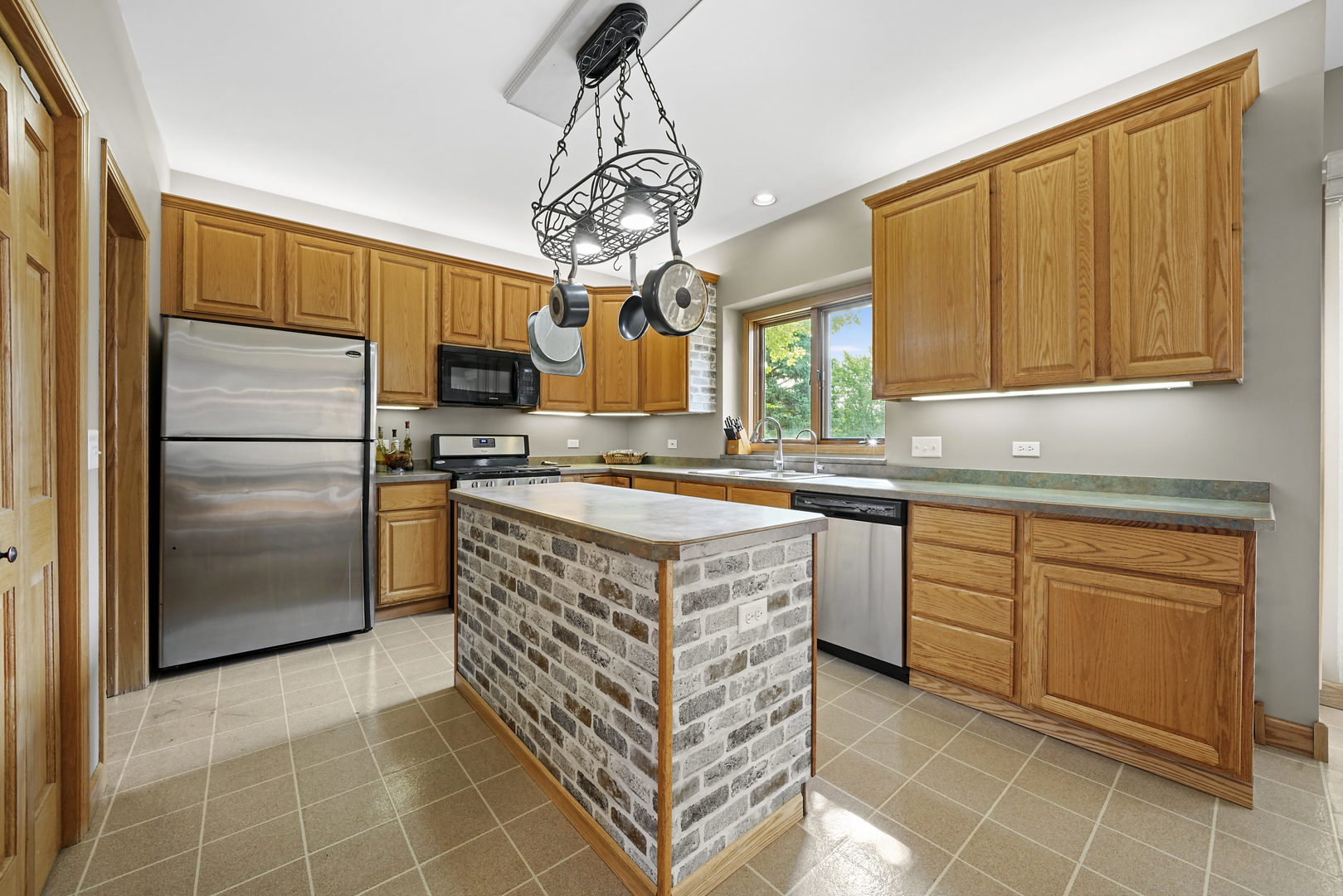 10808 Michigan Drive Spring Grove, IL 60081 - Photo 13 of 26 a kitchen with stainless steel appliances granite countertop a stove a refrigerator and a sink