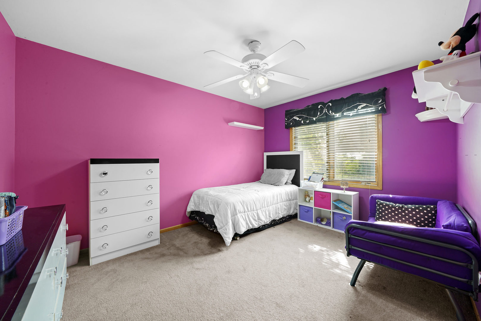 10808 Michigan Drive Spring Grove, IL 60081 - Photo 17 of 26 a bedroom with a bed and a chandelier