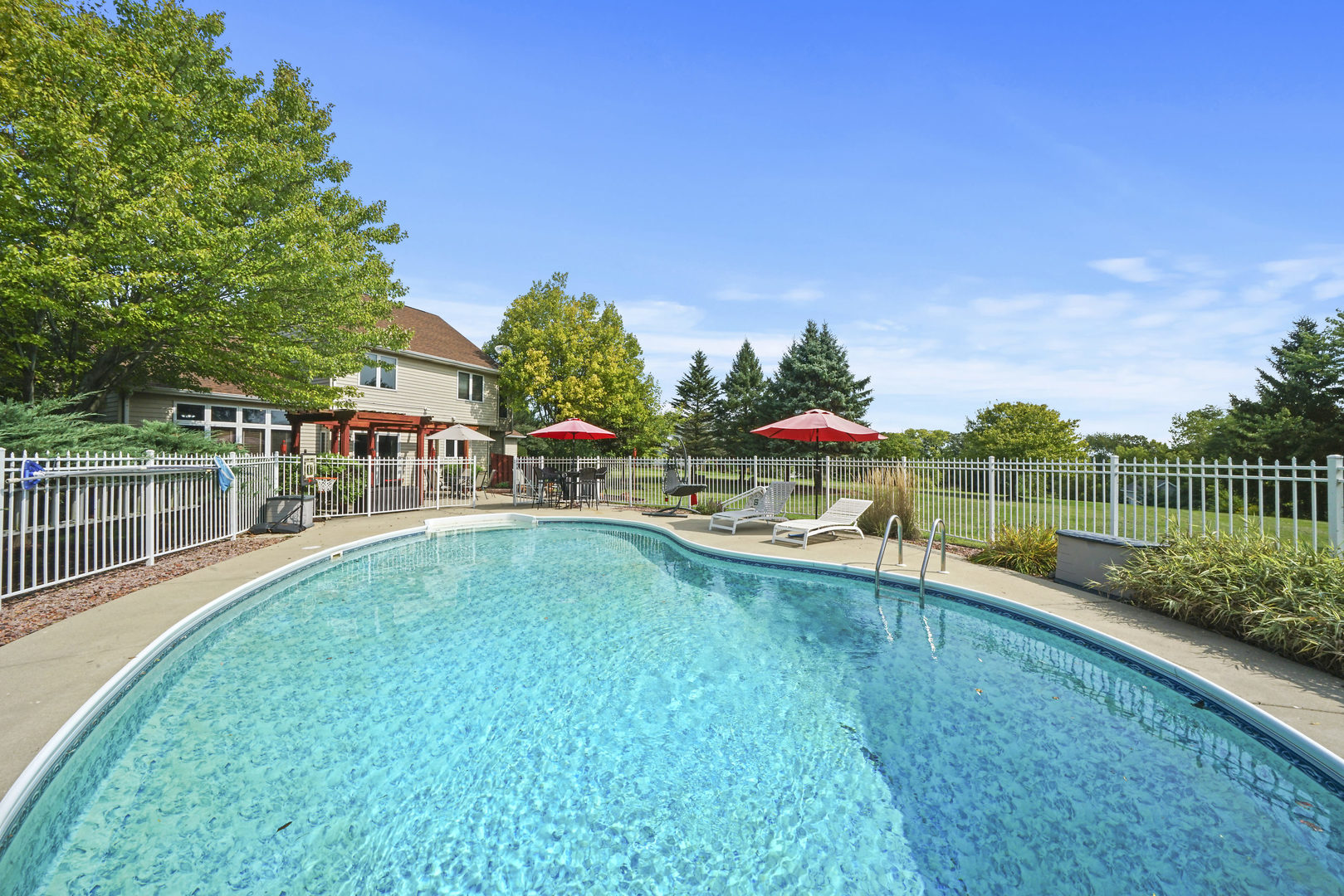 10808 Michigan Drive Spring Grove, IL 60081 - Photo 3 of 26 a view of a swimming pool with a patio and a garden