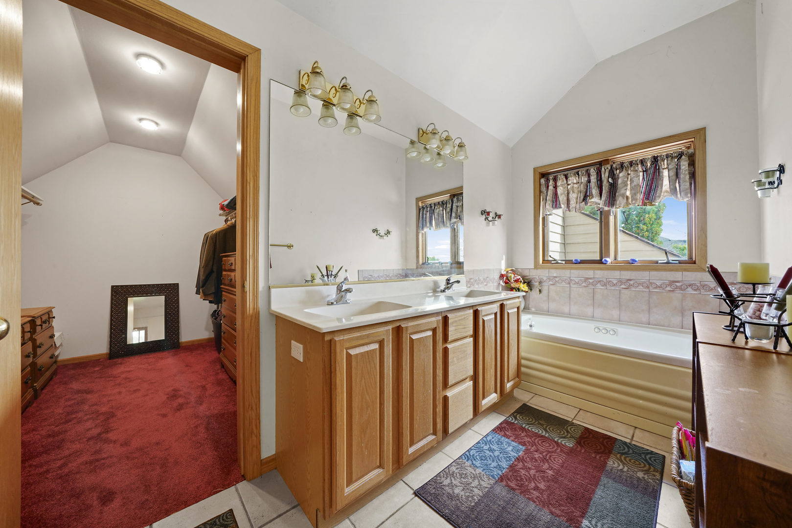 10808 Michigan Drive Spring Grove, IL 60081 - Photo 22 of 26 a spacious bedroom with a bed a dresser and potted plant on the dresser