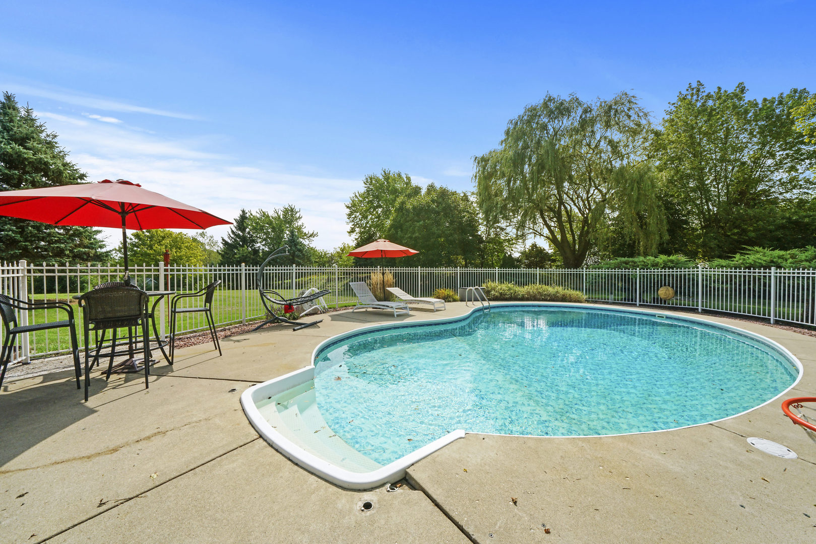10808 Michigan Drive Spring Grove, IL 60081 - Photo 4 of 26 a view of a swimming pool with a patio