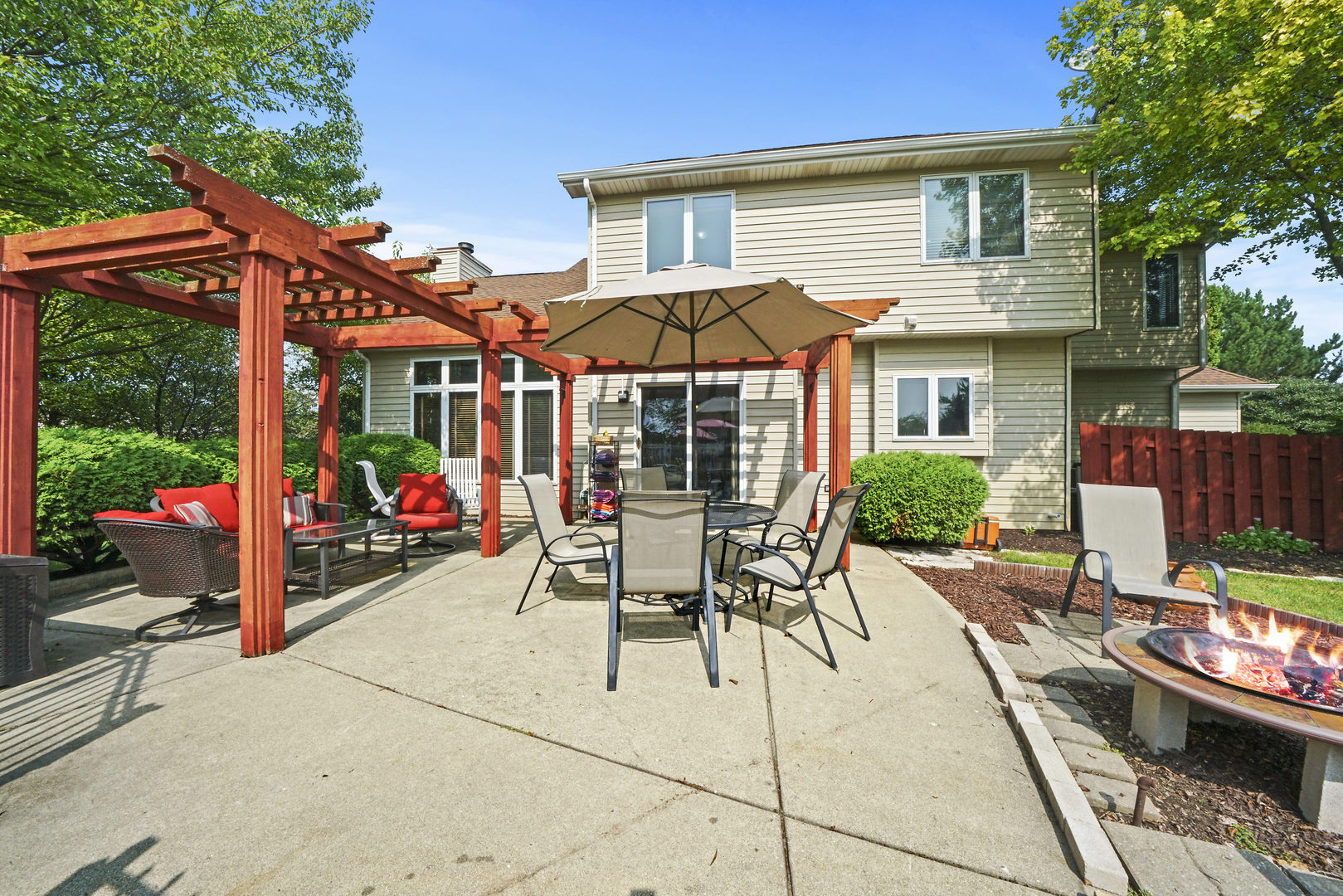 10808 Michigan Drive Spring Grove, IL 60081 - Photo 5 of 26 a view of a patio with table and chairs under an umbrella