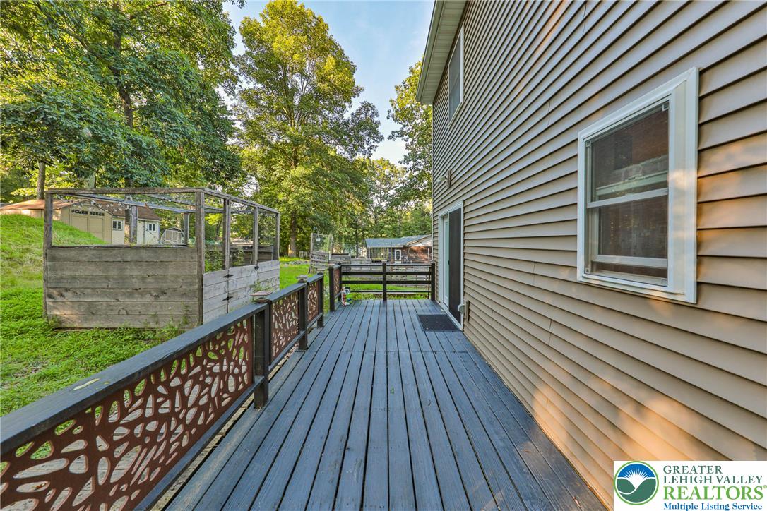 2114 Lakeview Road Bushkill, PA 18324 - Photo 67 of 83 An elevated wood deck spans the side of this vinyl-sided home overlooking mature trees.