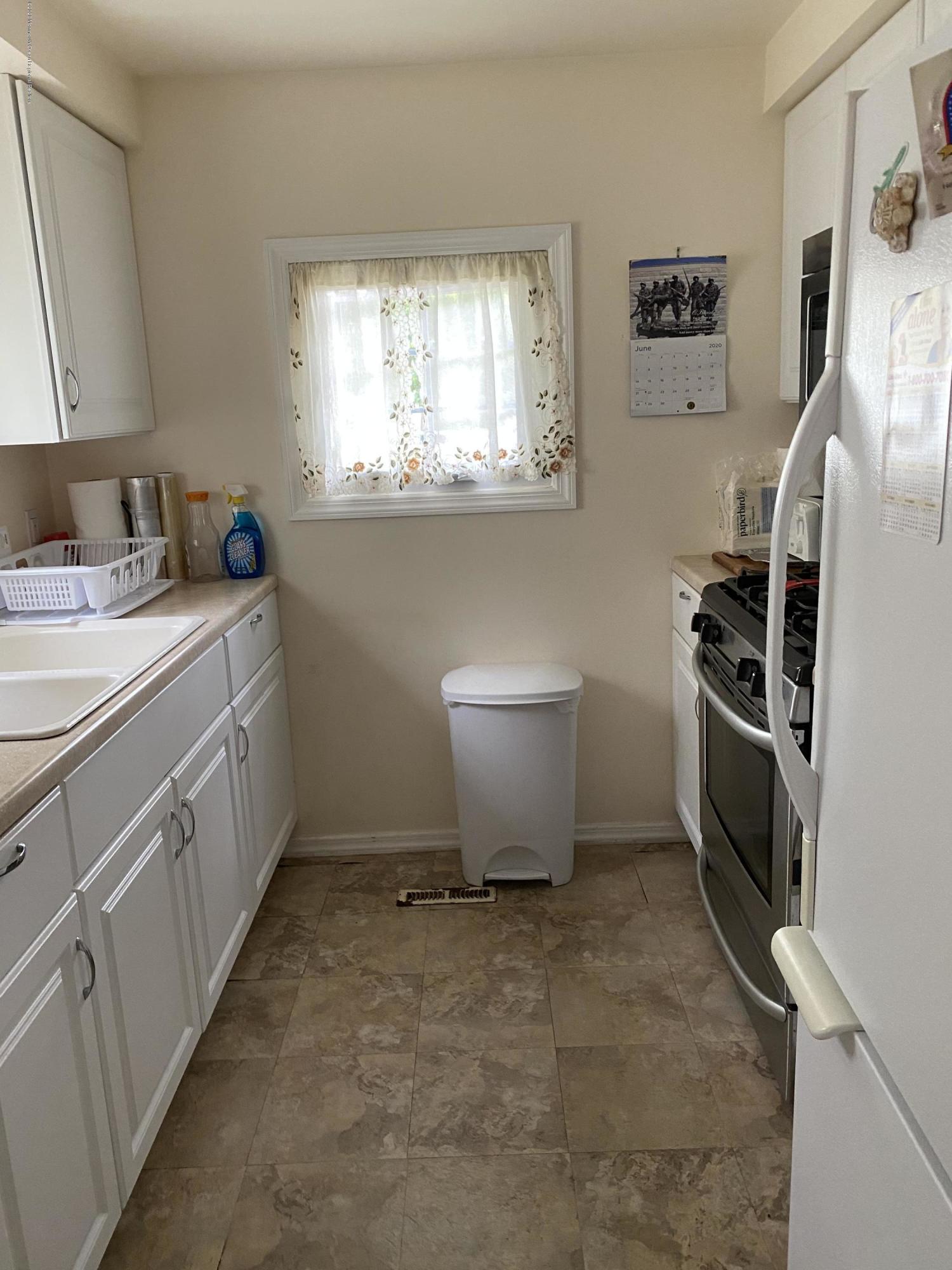 504 Roberts Road Toms River, NJ 08755 - Photo 12 of 34 a room with a white cabinets and white appliances