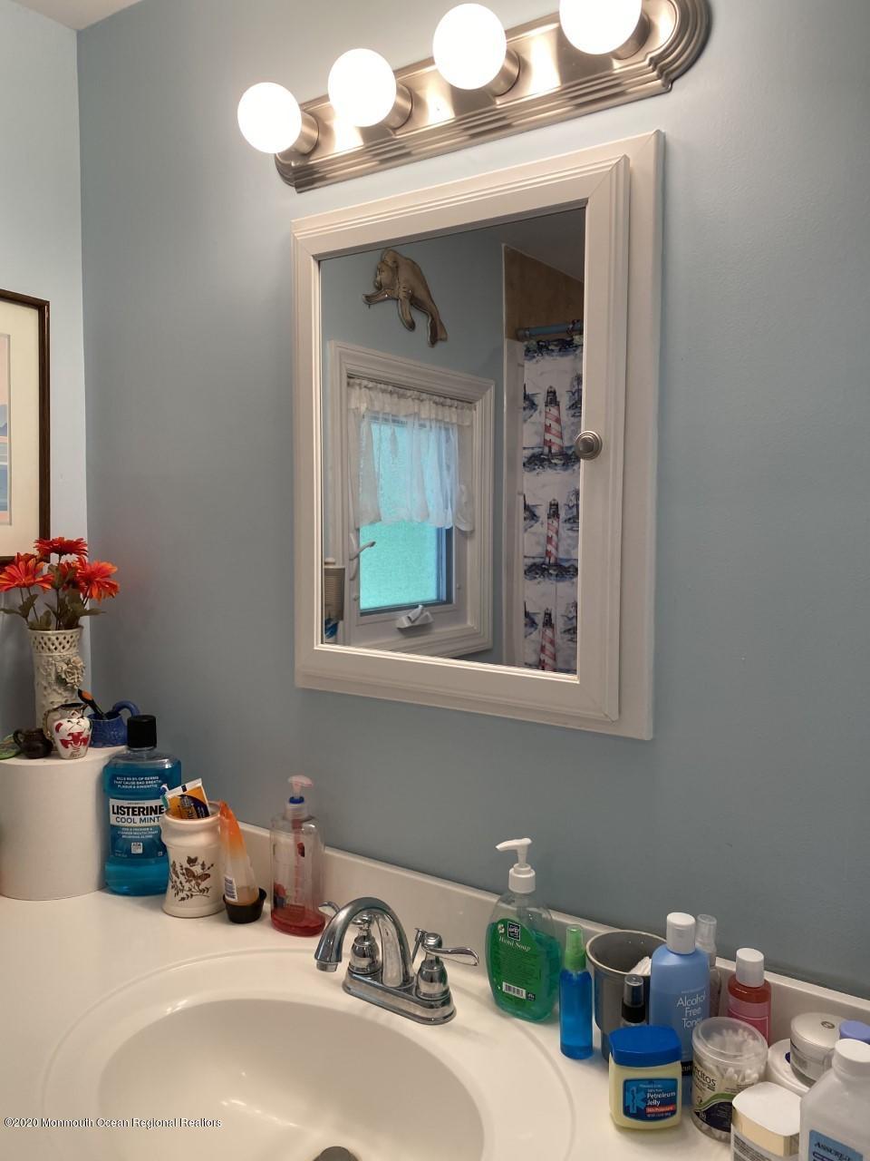 504 Roberts Road Toms River, NJ 08755 - Photo 19 of 34 a bathroom with a sink mirror and vanity