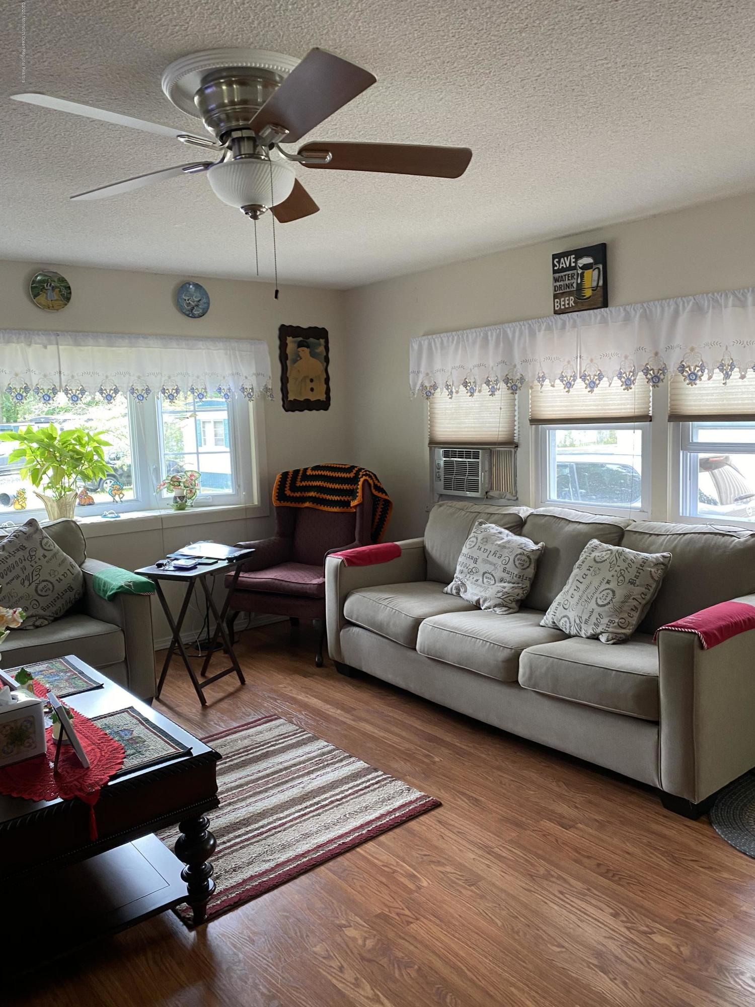 504 Roberts Road Toms River, NJ 08755 - Photo 5 of 34 a living room with furniture a chandelier and a window