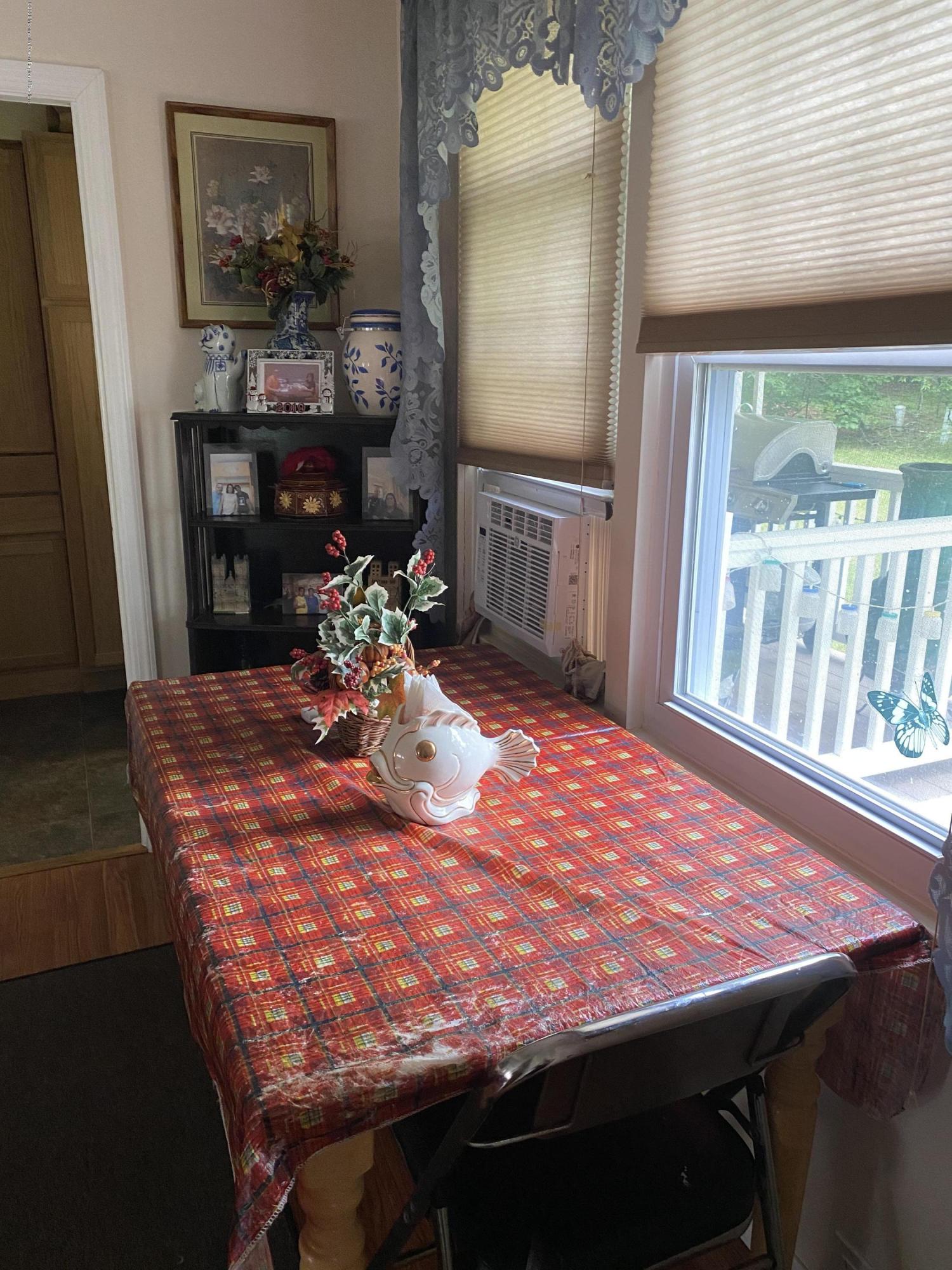 504 Roberts Road Toms River, NJ 08755 - Photo 10 of 34 a room with table chairs and a large window