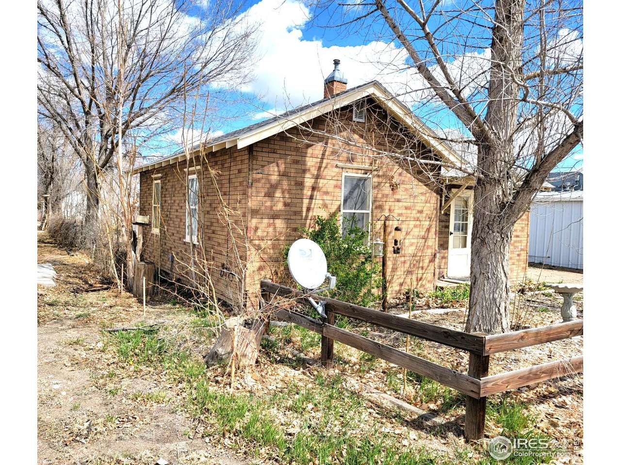 528 Phelps Street Sterling, CO 80751 - Photo 4 of 12 a backyard of a house with table and chairs