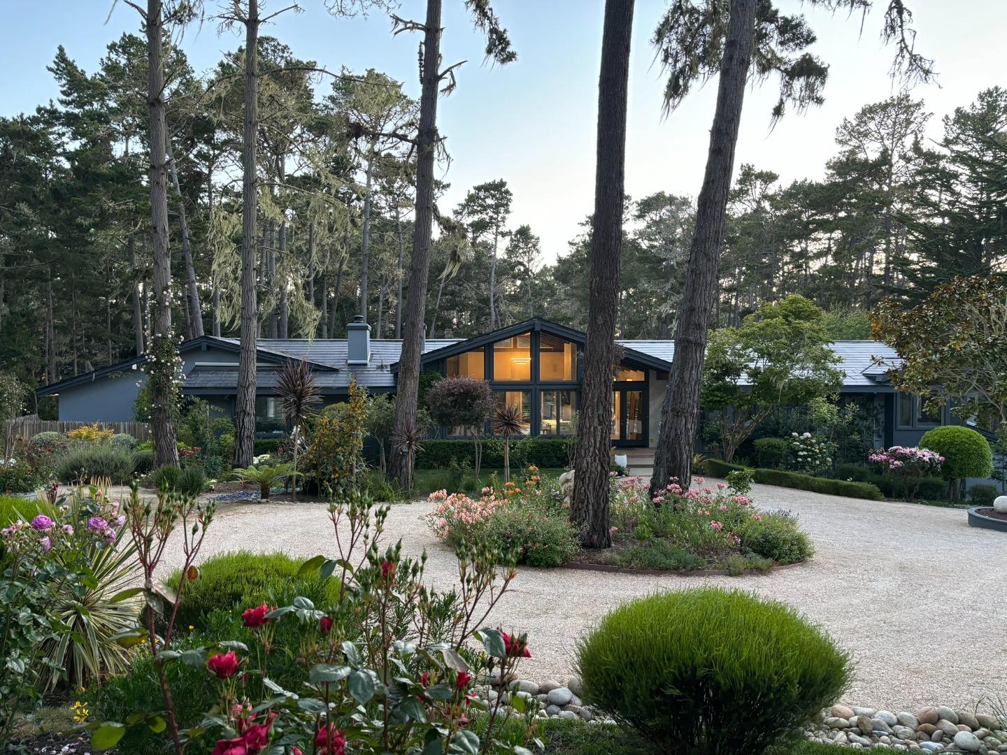 1276 Viscaino Road Pebble Beach, CA 93953 - Photo 1 of 64 a view of a garden with a building in the background