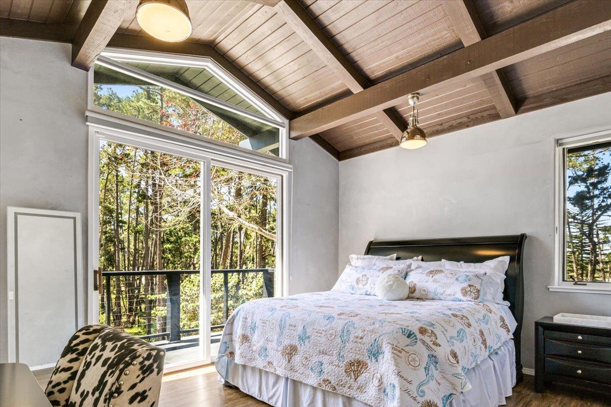 1276 Viscaino Road Pebble Beach, CA 93953 - Photo 23 of 64 a bedroom with a bed and a large window