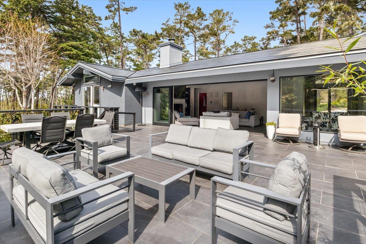 1276 Viscaino Road Pebble Beach, CA 93953 - Photo 34 of 64 a view of a patio with table and chairs and potted plants