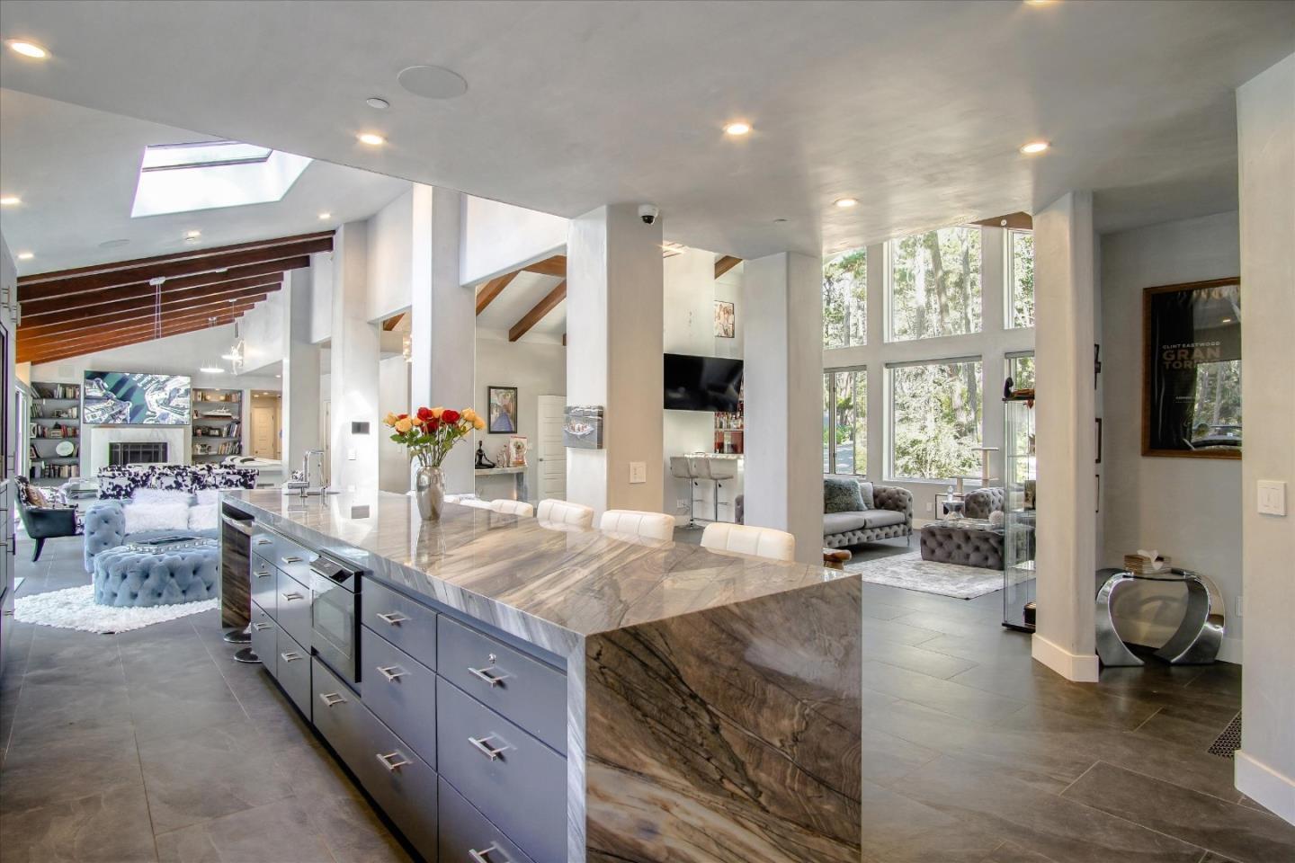1276 Viscaino Road Pebble Beach, CA 93953 - Photo 62 of 64 a kitchen with stainless steel appliances granite countertop sink stove and wooden floor