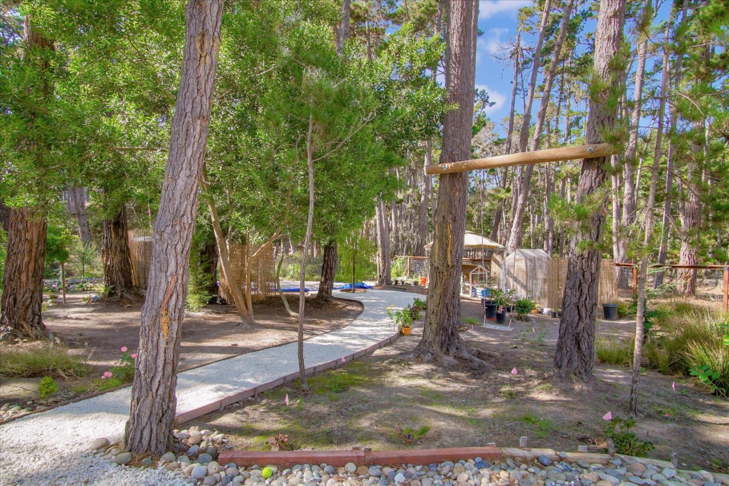 1276 Viscaino Road Pebble Beach, CA 93953 - Photo 64 of 64 a view of a park with swings and a pathway
