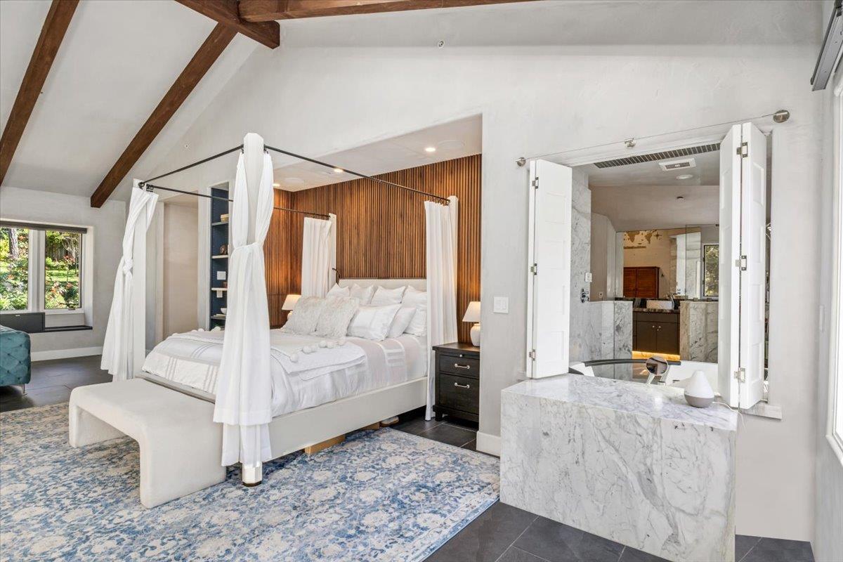 1276 Viscaino Road Pebble Beach, CA 93953 - Photo 8 of 64 a bedroom with a bed and large mirror