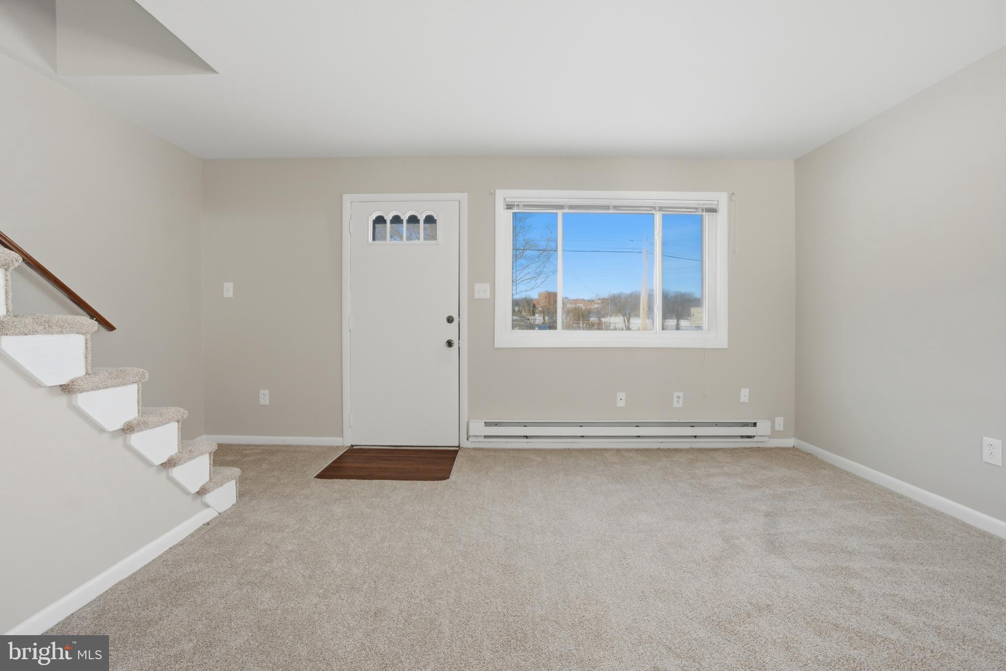 5605 Shelbourne Road, Unit B Baltimore, MD 21227 - Photo 2 of 20 an empty room with windows
