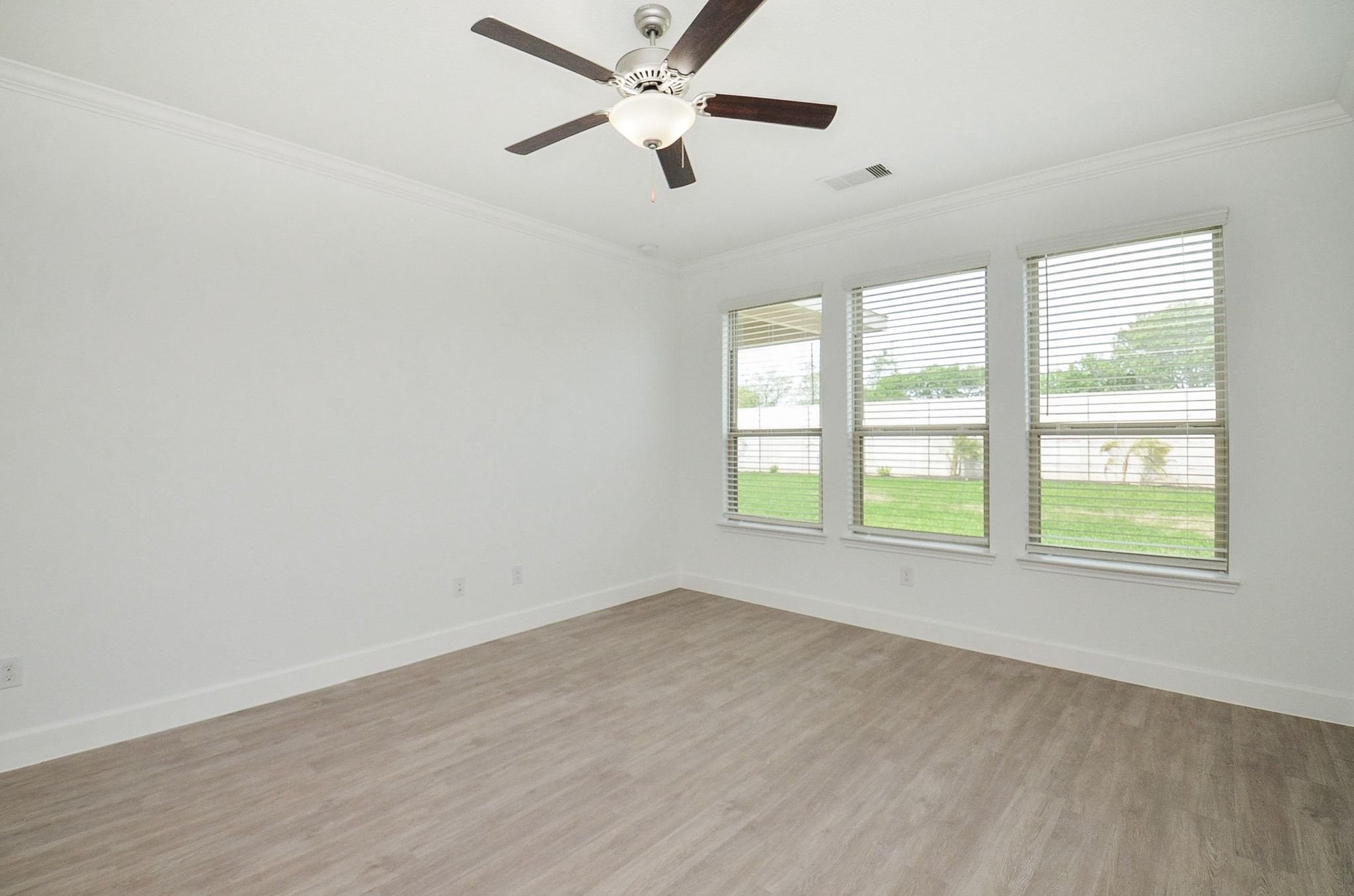 3820 Vista Grove Court Rosenberg, TX 77469 - Photo 22 of 36 Primary bedroom on first floor with new flooring and view of back yard