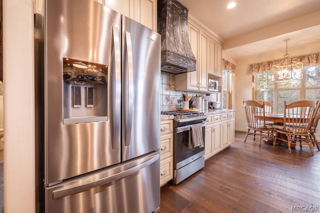 1629 Angels Camp Road Big Bear City, CA 92314 - Photo 12 of 40 a kitchen with stainless steel appliances granite countertop a refrigerator a stove and a dining table with wooden floor